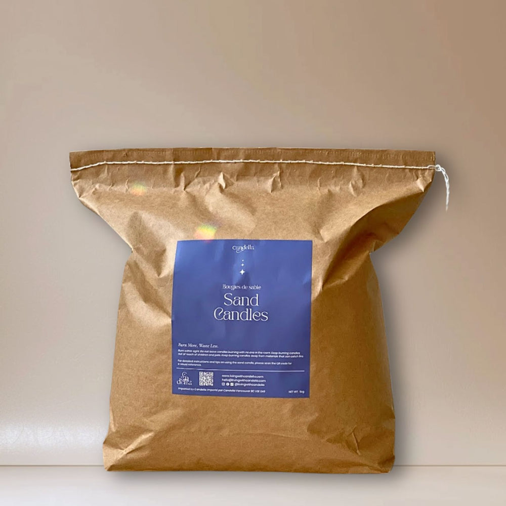 A kraft 5kg bag of sand candle wax labeled "Candella Sand Candles" with blue packaging and text in English and French, designed for event vendors for a sustainable candle experience.