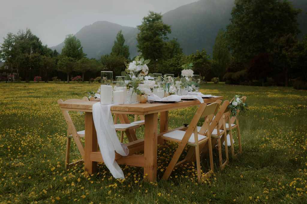 Garden-themed reception decor featuring Candellas sand candles and an array of flowers, creating a whimsical and enchanting atmosphere.