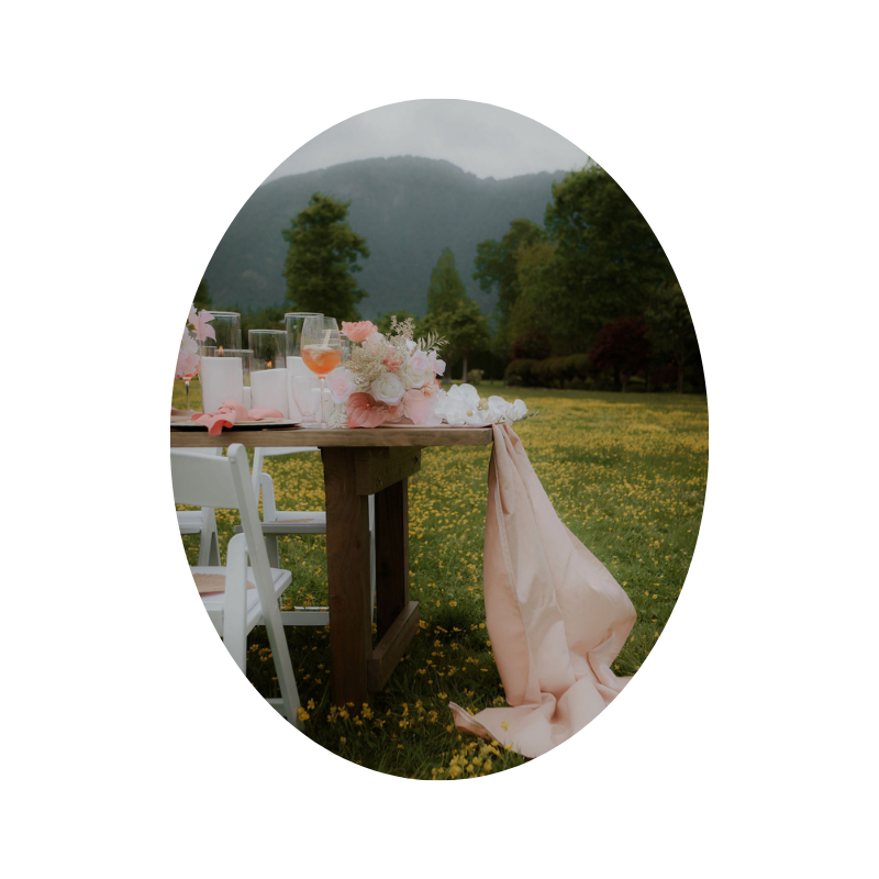 Garden-themed reception decor featuring Candellas sand candles and an array of flowers, creating a whimsical and enchanting atmosphere.