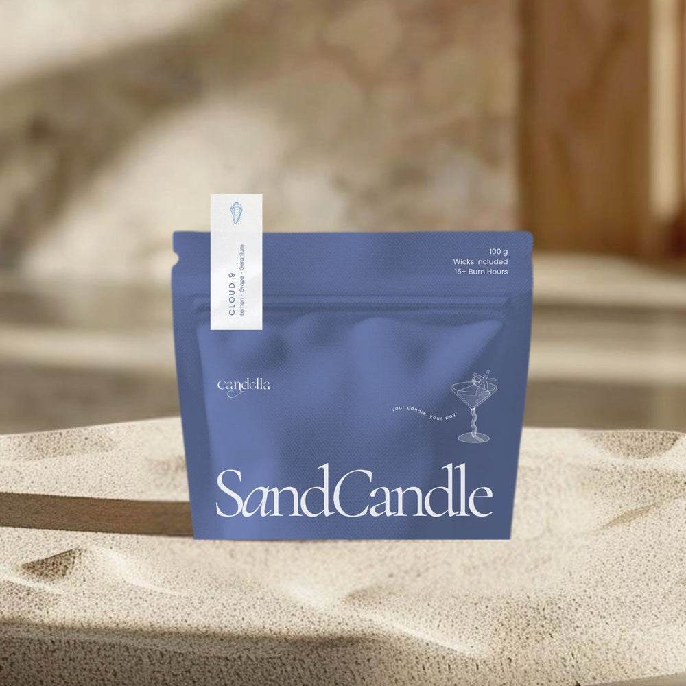 
                      
                        A product image of a Candella "SandCandle" package in a deep blue color. The minimalist pouch displays a small illustration of a cocktail glass with text reading "Your Candle, Your Way." A label at the top left corner identifies the scent as "CLOUD 9" with notes of "Lemon, Grape, Geranium".
                      
                    