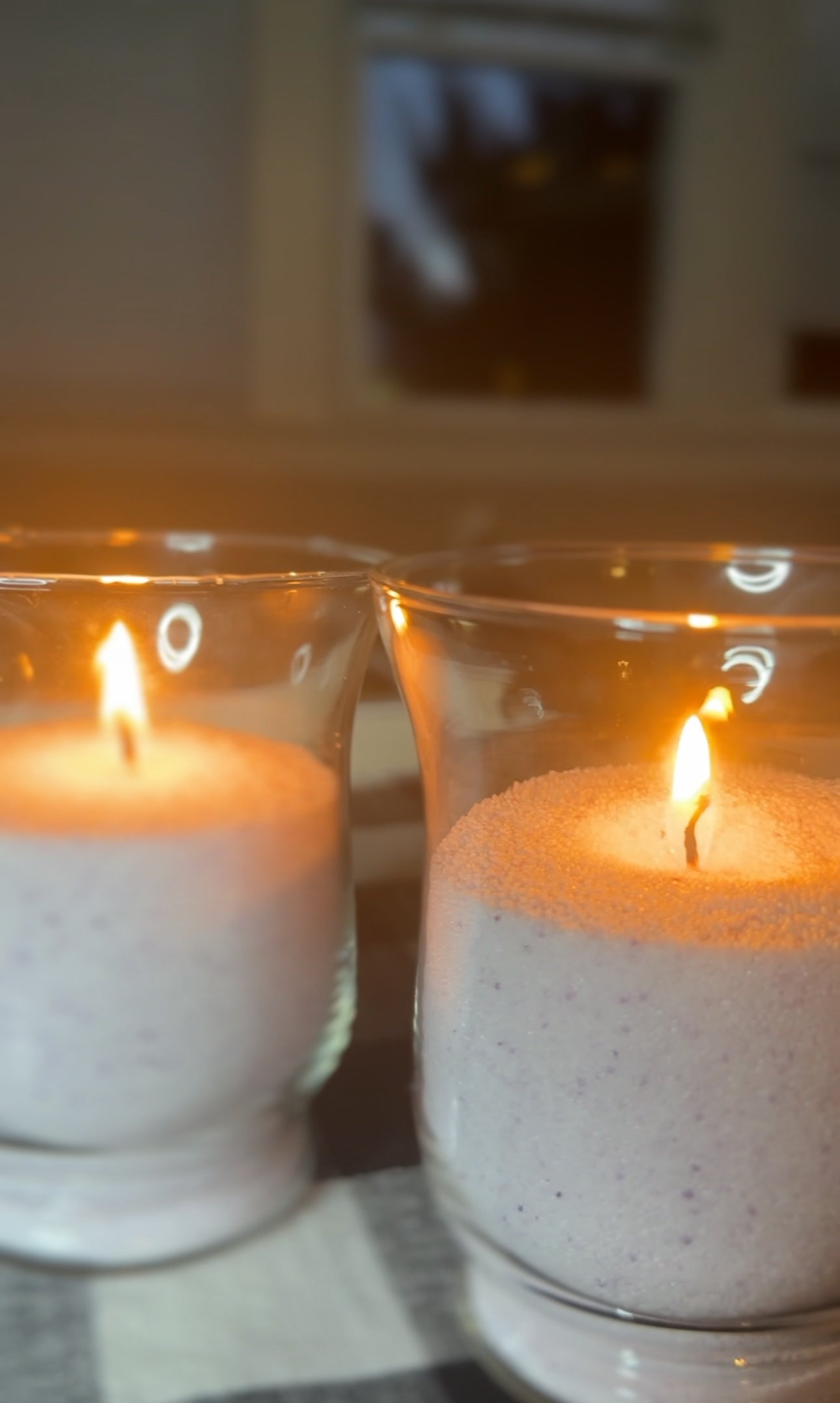 a container filled with candella's sand candle, ugc photo.