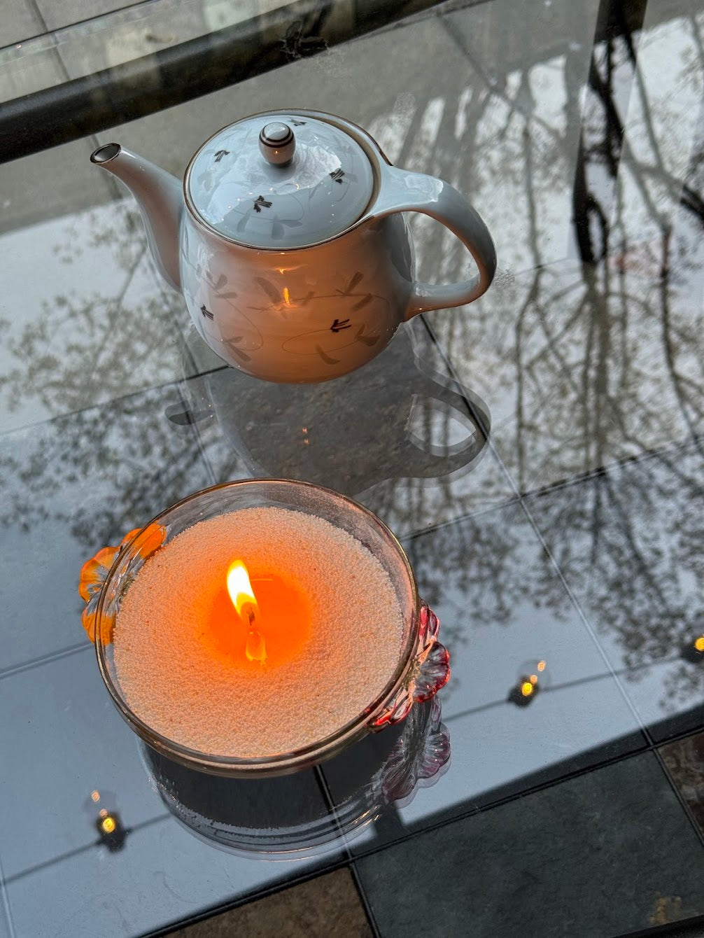 sand candle lighting in a vintage glass fruit bowl