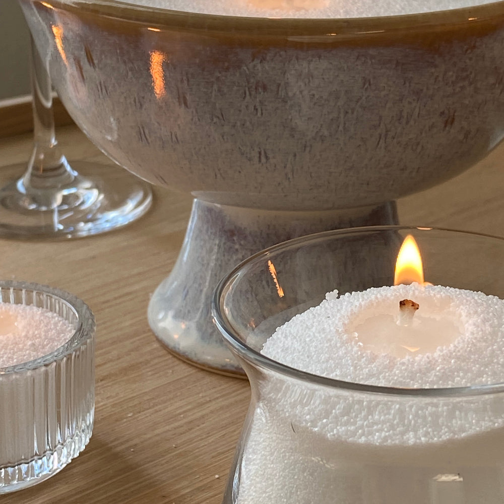 candellas white sand candles lighting in different type of containers (ceramic, glass vases)