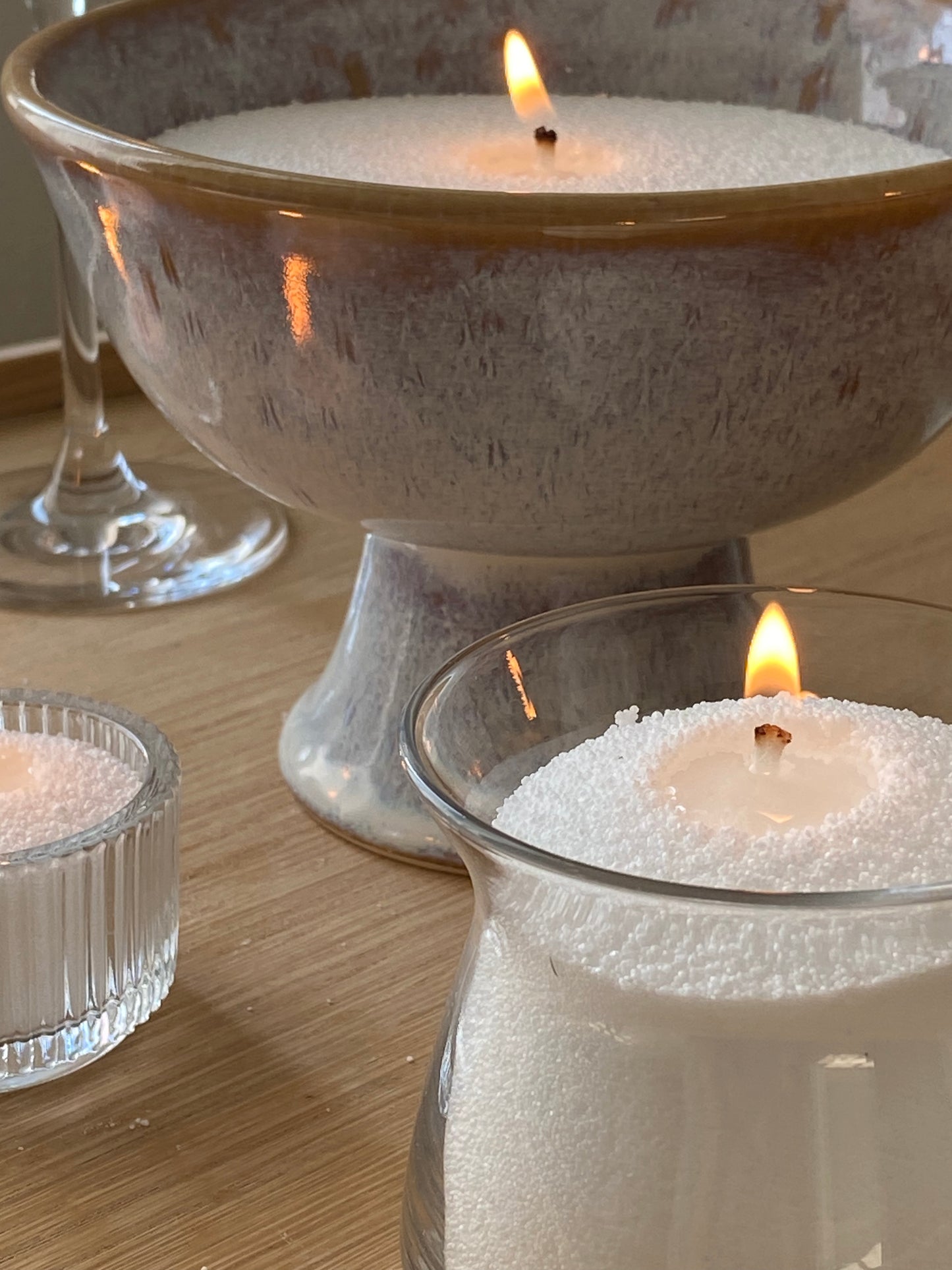 candellas white sand candles lighting in different type of containers (ceramic, glass vases)