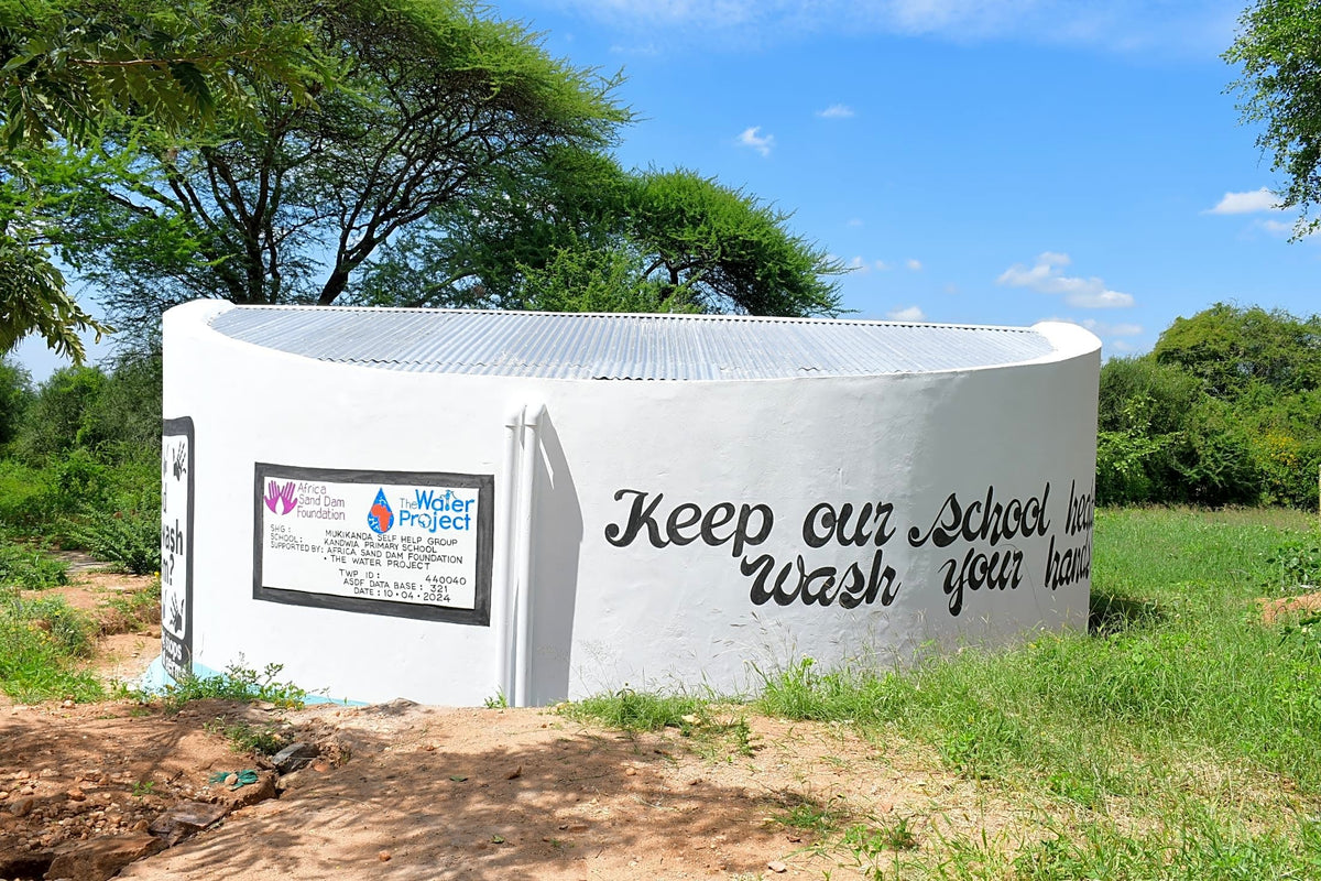 The Water Project — clean water tank built through Candella partnership