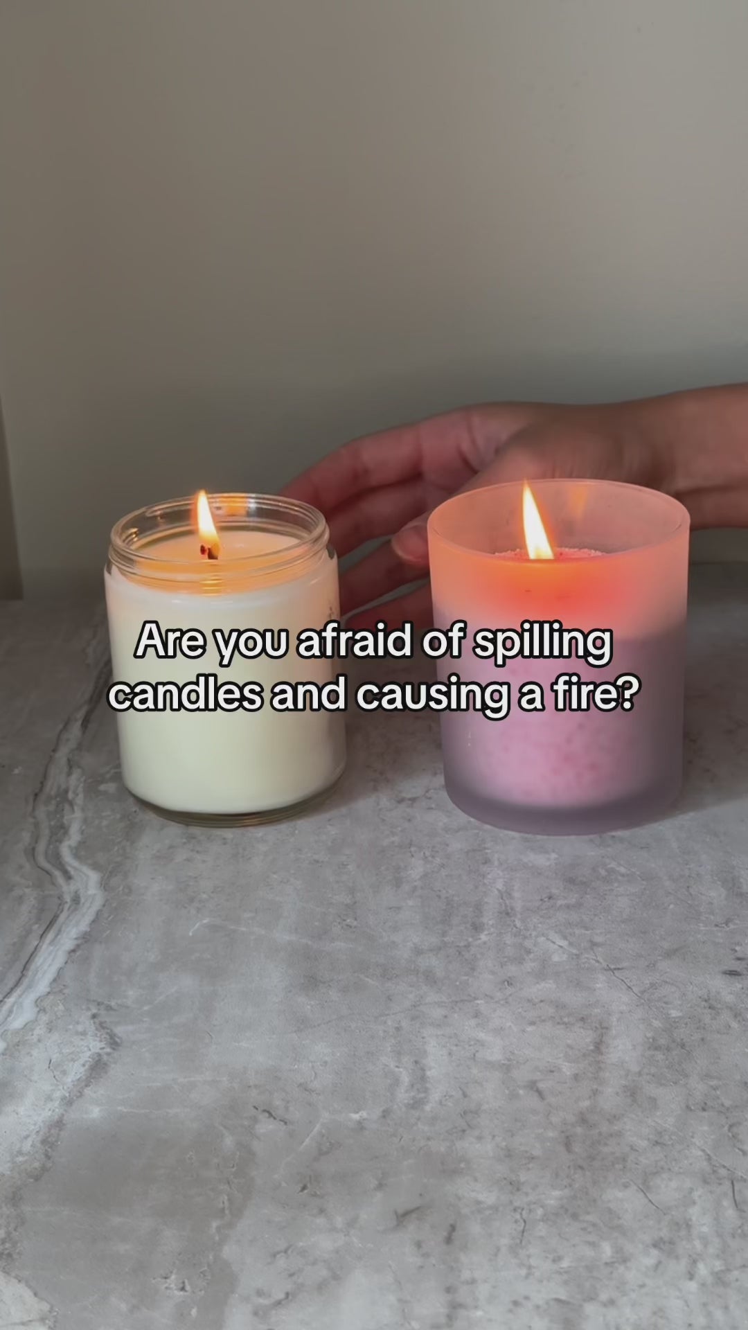 A video demonstrating how a sand candle self-extinguishes when knocked over, compared to a regular candle that remains lit even after being tipped